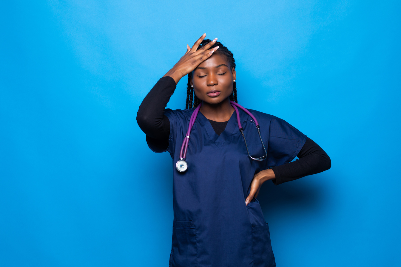 Young nurse stressed out and upset at work